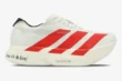 Side view of white Adidas Adizero Adios Pro 4 running shoe with red stripes and 'To run is to live!' text. - SKU JR6363