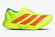Adidas Adizero Adios Pro 4 running shoe in neon yellow and orange, side profile view. - SKU JQ1571