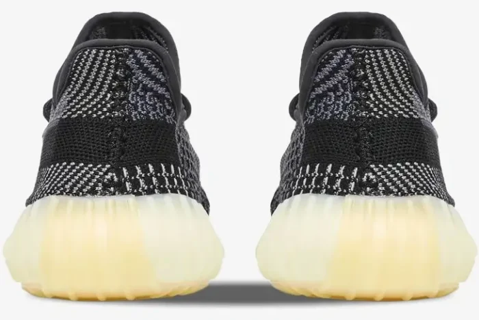 Rear view of Adidas Yeezy 350 V2 Carbon sneakers showing the black knit pattern and cream sole. - SKU FZ5000