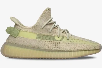 Side profile view of the Adidas Yeezy 350 V2 Flax sneaker in pale yellow and beige. - SKU FX9028