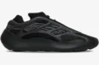 Side profile of the Adidas Yeezy 700 V3 Alvah sneaker in black and grey with a futuristic cage design. - SKU H67799