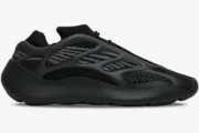 Side profile of the Adidas Yeezy 700 V3 Alvah sneaker in black and grey with a futuristic cage design. - SKU H67799
