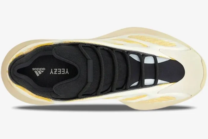 Top-down view of Adidas Yeezy 700 V3 Safflower sneakers in yellow and cream with black laces. - SKU G54853