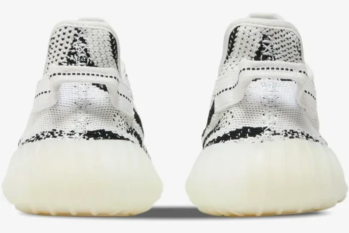 Rear view of Adidas Yeezy Boost 350 V2 Zebra sneakers showing the white and black knit pattern and heel pull tabs. - SKU CP9654