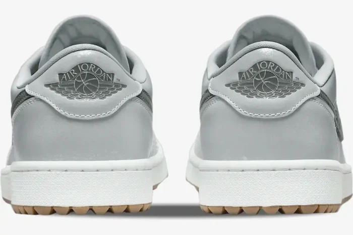 Rear view of Air Jordan 1 Low Wolf Grey sneakers showing silver wings logos and spiked gum outsoles. - SKU DD9315-006