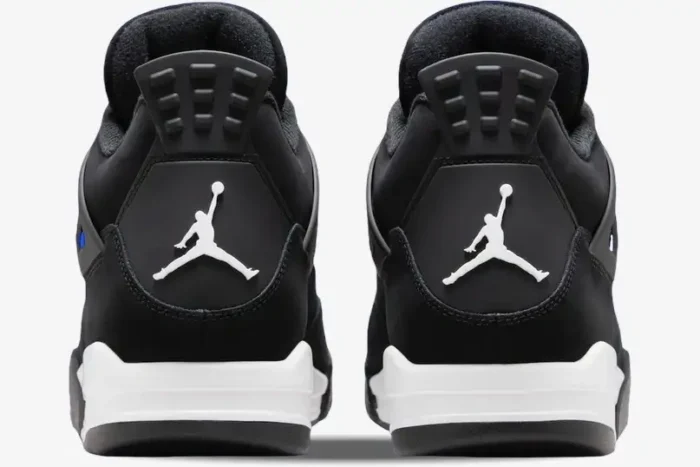 Rear view of black and white Air Jordan 4 Retro sneakers featuring the white Jumpman logo on the heels. - SKU FQ8138-001
