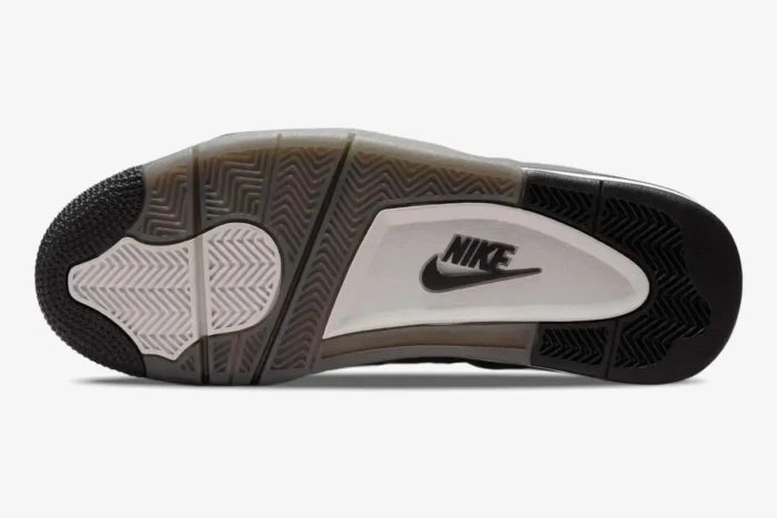 Bottom view of the Air Jordan 4 Retro Cave Stone and Black outsole featuring a Nike logo and herringbone pattern. - SKU  FV5029-200