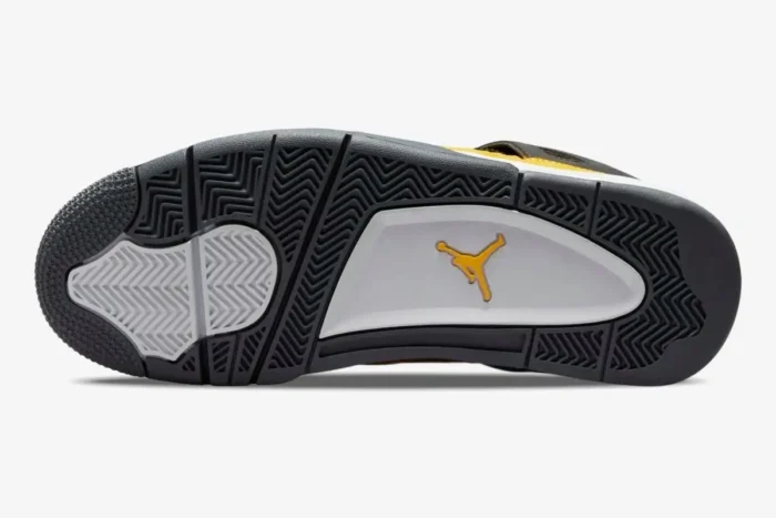 Bottom view of Air Jordan 4 Retro Lightning outsole featuring dark grey, white, and yellow Jumpman logo. - SKU CT8527-700