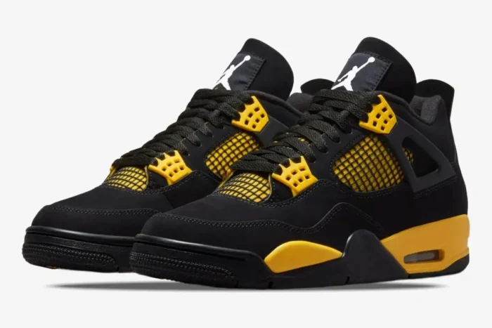 Air Jordan 4 Retro Thunder sneakers in black and tour yellow, three-quarter front view. - SKU DH6927-017
