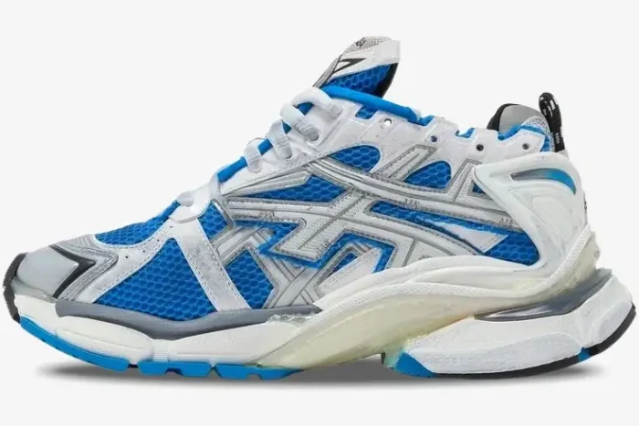 Side profile of a Balenciaga Runner Sneaker in blue, white, and grey with a distressed mesh design. - SKU 677403W3RB34912