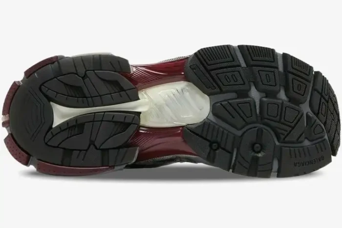Bottom view of a Balenciaga Runner Sneaker in burgundy and silver showing the complex textured outsole. - SKU 677403W3RB39069