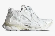 Side view of white Balenciaga Runner sneakers featuring a chunky, multi-layered mesh and nylon design. - SKU 772774W3RMU9000