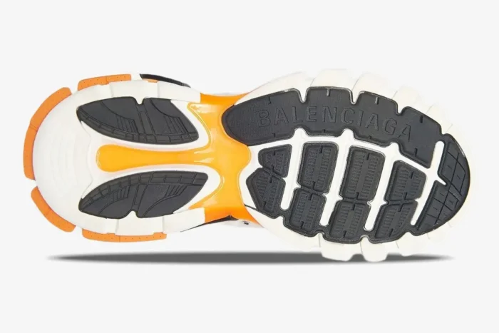 Bottom view of the white and orange Balenciaga Track sneaker outsole with black and orange tread patterns. - SKU 542023W1GB19059
