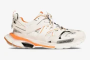 Balenciaga Track sneakers in white and orange, side profile view on a plain white background. - SKU 542023W1GB19059