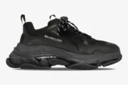 Side profile of a Balenciaga Triple S Clear Sole sneaker in black with a chunky translucent sole. - SKU 541624W2FB11000