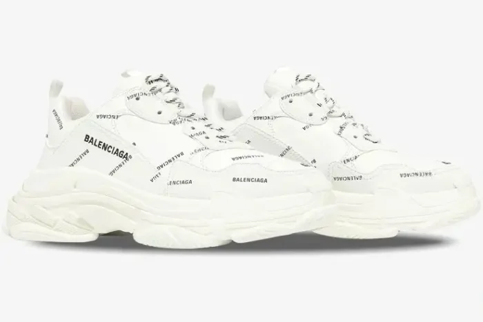 White Balenciaga Triple S sneakers with black all-over logo print, side three-quarter view. - SKU 536737W2FA19010
