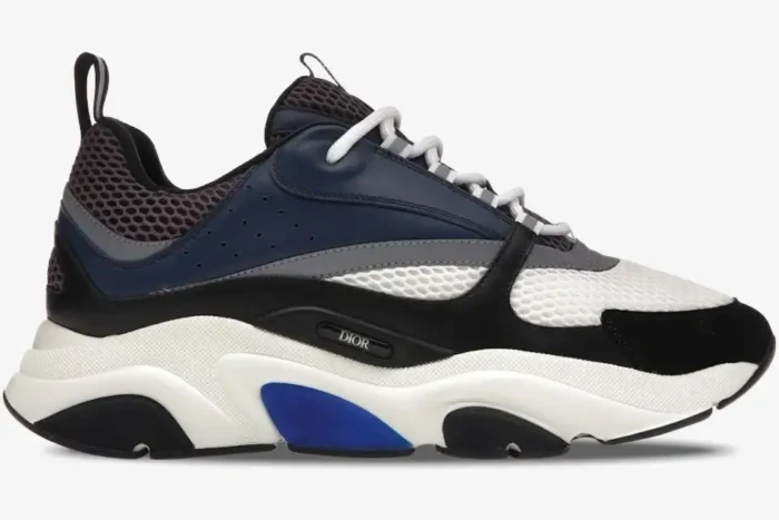 Side profile of a Dior B22 sneaker in navy mesh and grey calfskin with a chunky white sole. - SKU 3SN231YKB_H560