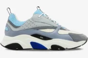 Side profile of a Dior B22 luxury sneaker in white, light blue, and grey with a chunky sole. - SKU 3SN231YXX_H865