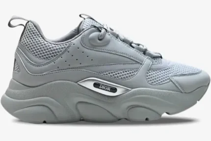 Side profile of a Dior B22 'Triple Grey' luxury sneaker featuring mesh and leather panels. - SKU 3SN231YKA804
