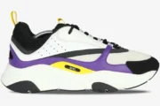 Side profile of a Dior B22 sneaker in violet, white, and black with yellow accents on a chunky sole. - SKU 3SN231YKA_H065