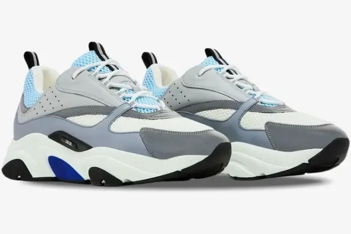 Dior B22 'White Blue' luxury sneakers in a side-profile view featuring grey and light blue mesh overlays. - SKU 3SN231YXX_H865