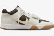 Side profile of Air Jordan Jumpman Jack TR x Travis Scott Sail sneaker with reverse swoosh and gum sole. - SKU FZ8117-100
