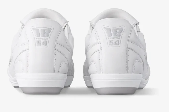 Rear view of white Louis Vuitton Footprint Soccer Sneakers showing the embossed 1854 heel logo. - SKU 1AFO4A