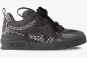 Side profile of a black Louis Vuitton LV Skate Sneaker with crystal monogram details and thick laces. - SKU 1ABY8S