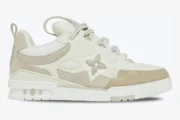 Louis Vuitton LV Skate Sneaker in beige and white, side profile view showing monogram flower detail. - SKU 1AARQS