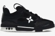 Side profile of a black and white Louis Vuitton LV Skate Sneaker featuring a large white flower logo. - SKU 1AARR1