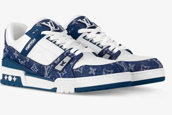 Louis Vuitton LV Trainer sneakers in white and blue monogram denim, three-quarter side view. - SKU 1A9JGR