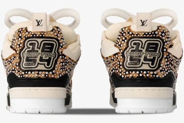 Back view of Louis Vuitton LV Trainer LV149 sneakers in beige, black, and brown with leopard print and silver studs.