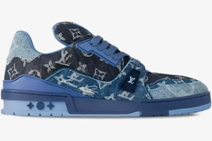 Side view of Louis Vuitton Trainer Monogram Denim Blue sneaker with textured denim and blue sole. - SKU 1AC4YN