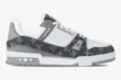 Side view of the Louis Vuitton Trainer featuring grey monogram denim and white pebbled leather. - SKU 1A9Z7C