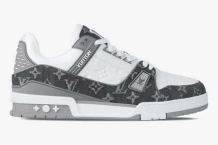 Side view of the Louis Vuitton Trainer featuring grey monogram denim and white pebbled leather. - SKU 1A9Z7C