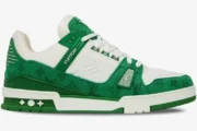 Side profile of a Louis Vuitton Trainer in green monogram denim and white leather with a green rubber sole. - SKU 1A9JHV-1A9JI1