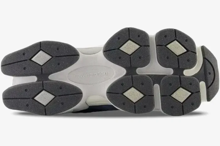 Outsole of New Balance 9060 Natural Indigo shoes showing the unique pod-like tread design in grey and indigo. - SKU U9060IND