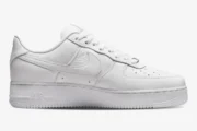 Side profile of a white Nike Air Force 1 Low x NOCTA Certified Lover Boy sneaker in tumbled leather. - SKU CZ8065-100