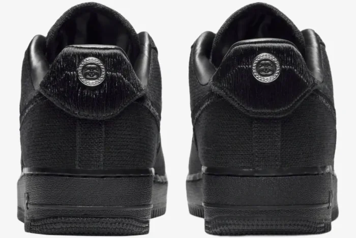 Rear view of Nike Air Force 1 Low x Stussy Triple Black Hemp sneakers with heel medallions. - SKU CZ9084-001