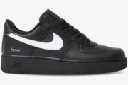 Side profile of Nike Air Force 1 Low x Supreme in black with a white swoosh and heel logo. - SKU SP1AF11