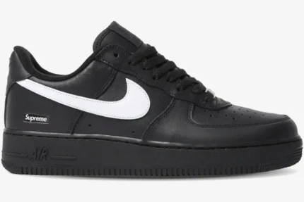 Side profile of Nike Air Force 1 Low x Supreme in black with a white swoosh and heel logo. - SKU SP1AF11