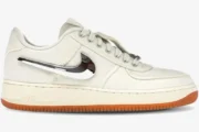 Nike Air Force 1 Low x Travis Scott 'Sail' sneaker in a side profile view with a chrome swoosh and gum sole. - SKU AQ4211-101