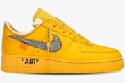 Side profile of Nike Air Force 1 Low x Off-White University Gold sneakers with a metallic silver Swoosh. - SKU DD1876-700