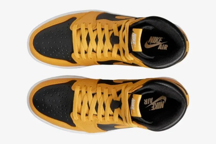 Top-down view of yellow and black Nike Air Jordan 1 High OG Pollen sneakers.