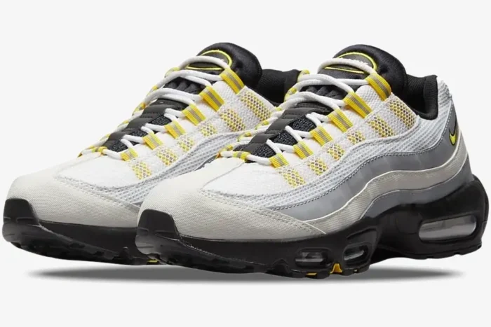 Nike Air Max 95 Tour sneakers in white, grey, and yellow, shown from a three-quarter front angle. - SKU 609048-105