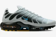 Nike Air Max Plus in grey and university blue, side profile view showing the gradient mesh and black overlays. - SKU DM0032-015