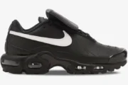 Side view of Nike Air Max Plus Tiempo hybrid sneakers in black leather with a white swoosh and visible air units. - SKU HF0074-001