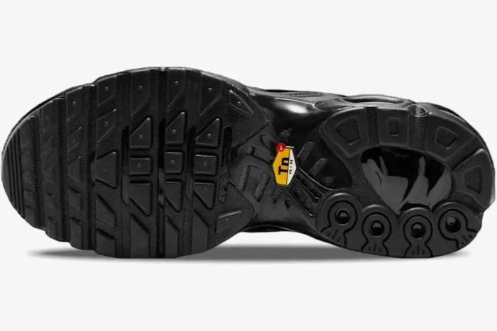 Bottom view of the Nike Air Max Plus TN Triple Black outsole featuring the yellow Tn Air logo. - SKU DM2362-002
