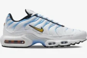 Nike Air Max Plus in White and University Blue, side profile view showing yellow Swoosh and visible Air units. - SKU DM0032-101