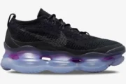 Nike Air Max Scorpion Flyknit in black and purple, side profile view showing the large translucent air sole. - SKU DR0888-001